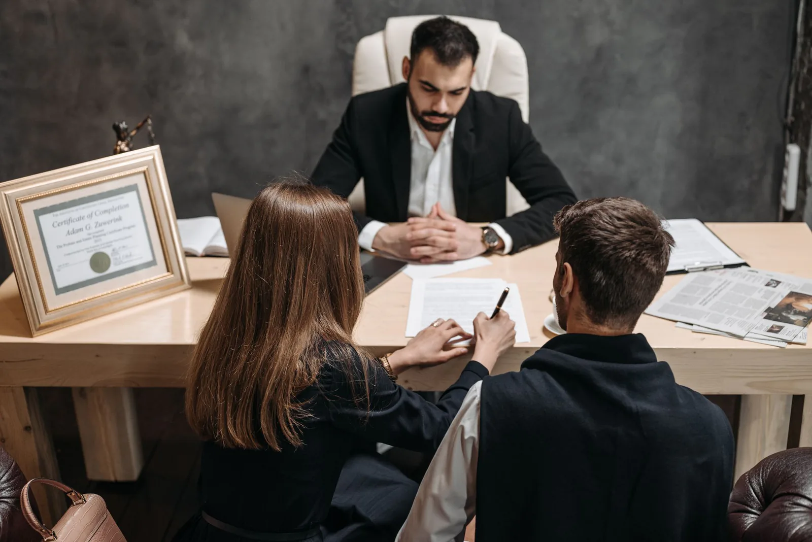 A lawyer discussing legal documents with clients in an office setting