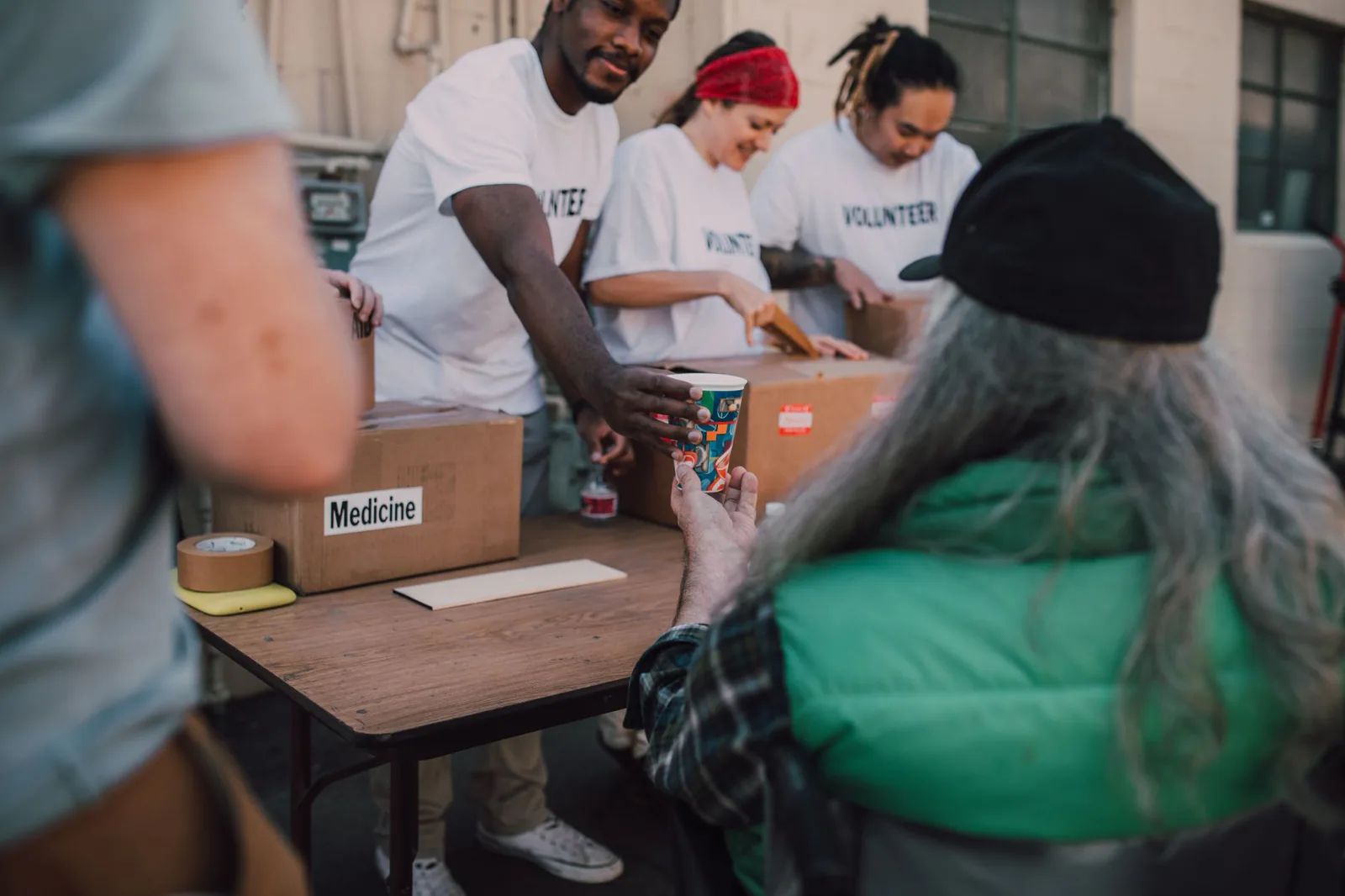 Volunteers handing out donations and support at a community event